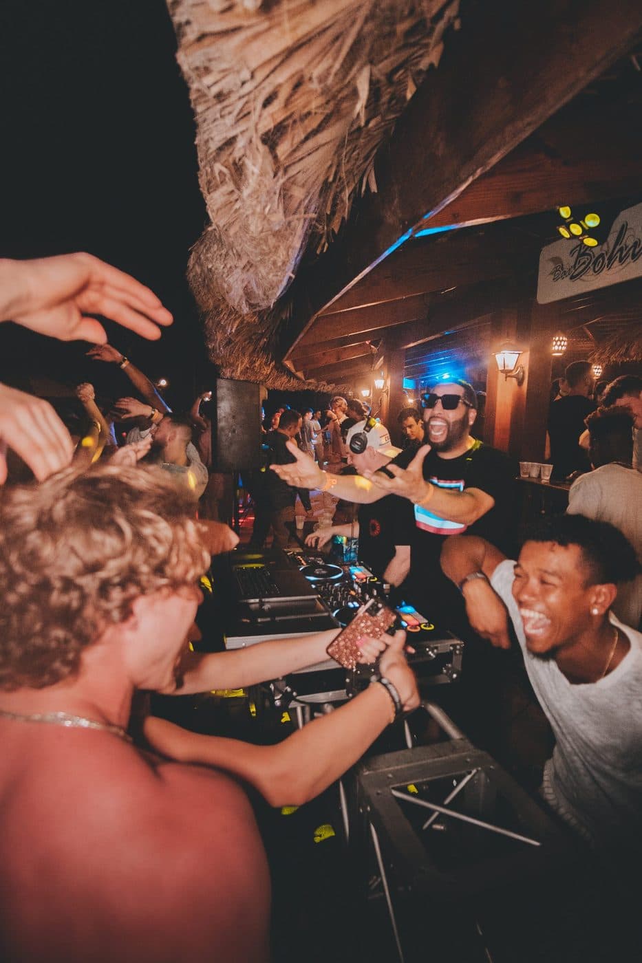 a group of people dancing at a party.