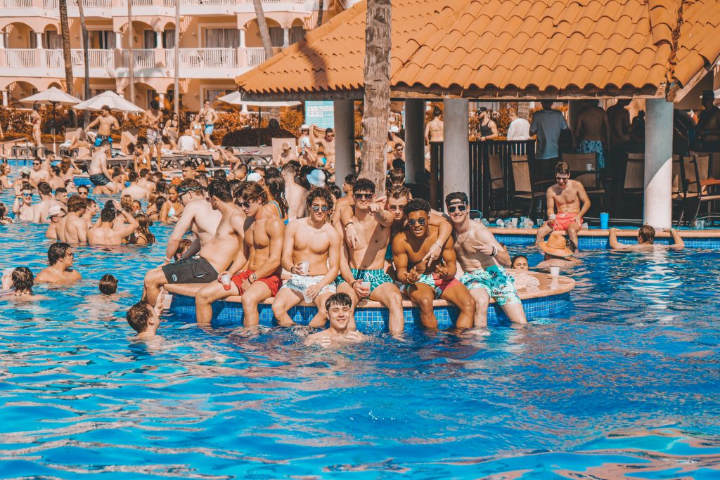 a group of people sitting on a raft in a swimming pool.